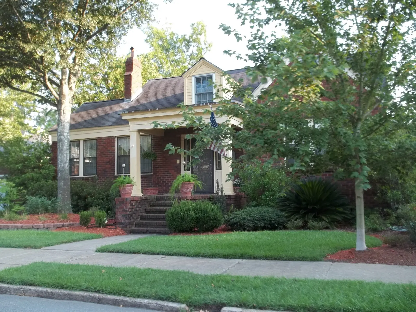 A brick house on a tree-lined street in Savannah's Ardsley Park-Chatham Crescent Historic District