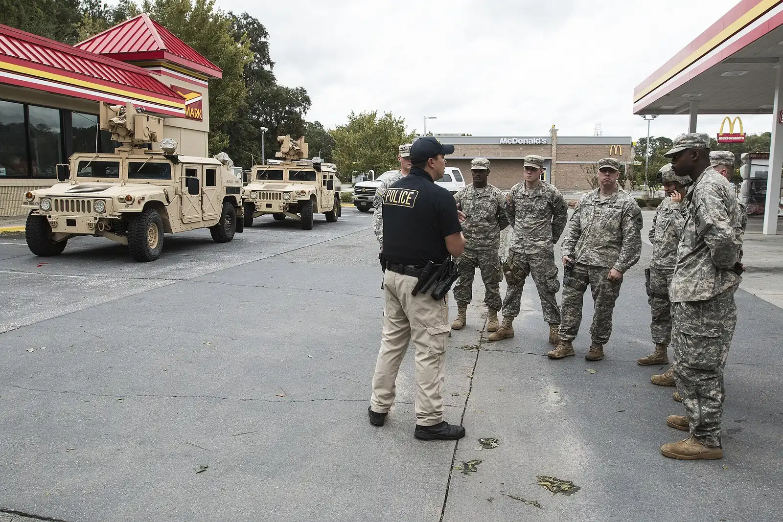 A Savannah-Chatham police sergeant briefs Georgia National Guard military police in west Chatham County during the Hurricane Matthew response.