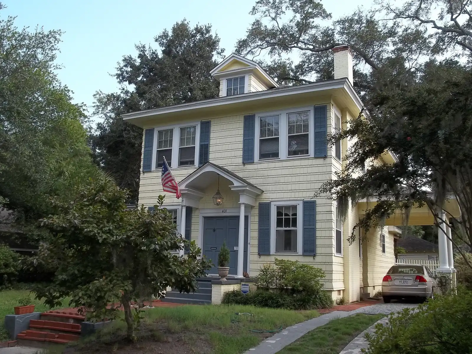 A two-story house with blue shutters in Savannah's Gordonston neighborhood