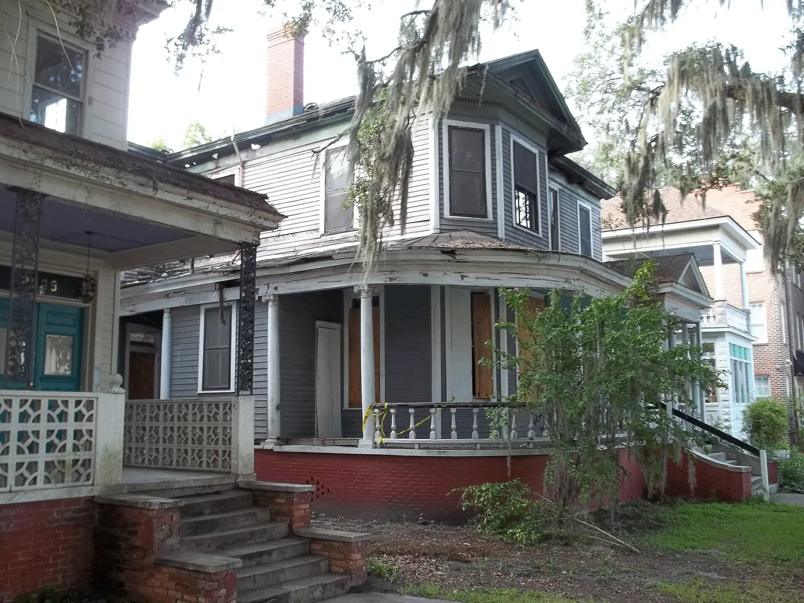A two-story house with porches under live oaks in Savannah's Thomas Square neighborhood