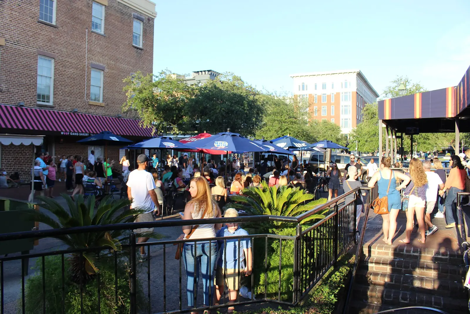 Outdoor tables under umbrellas in City Market in downtown Savannah.