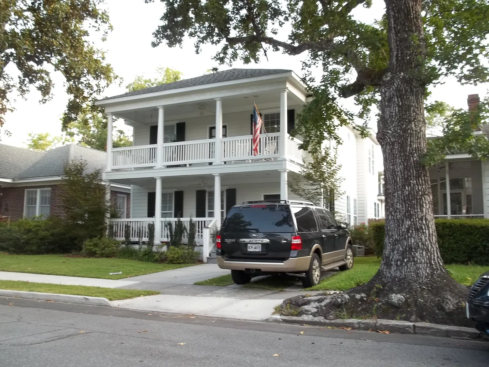 A two-story house with a front porch in the Ardsley Park and Chatham Crescent area, zoned for J.G. Smith