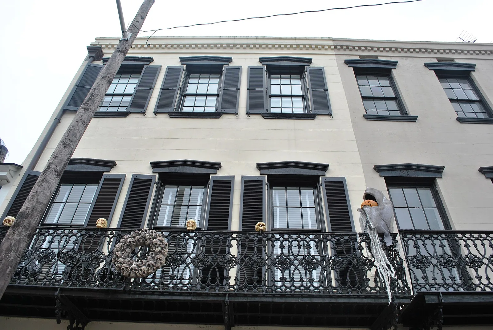 Skulls, a jack-o'-lantern and a ghost decorate the iron balcony of a historic house in downtown Savannah.